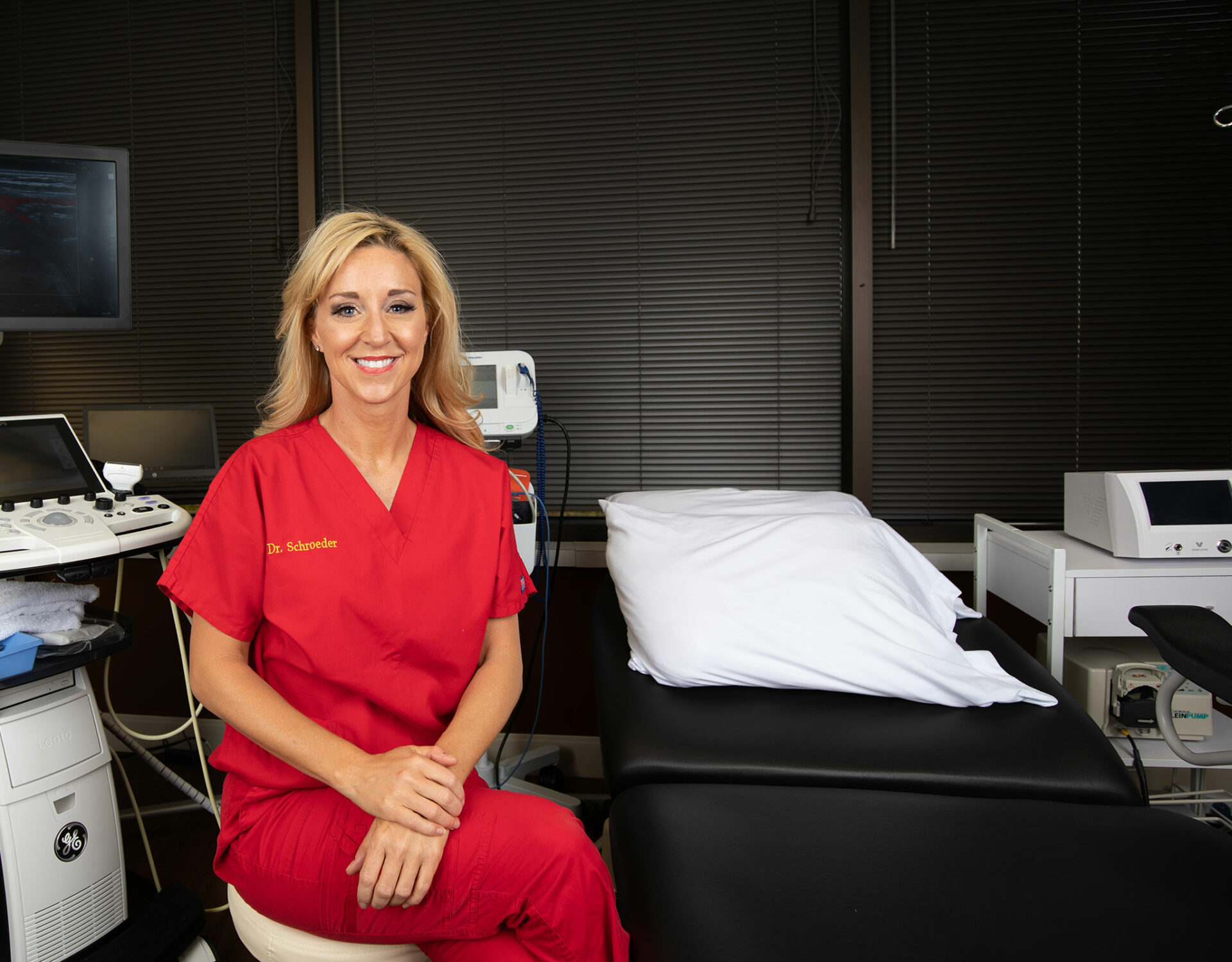 A woman smiling into the camera in her office.